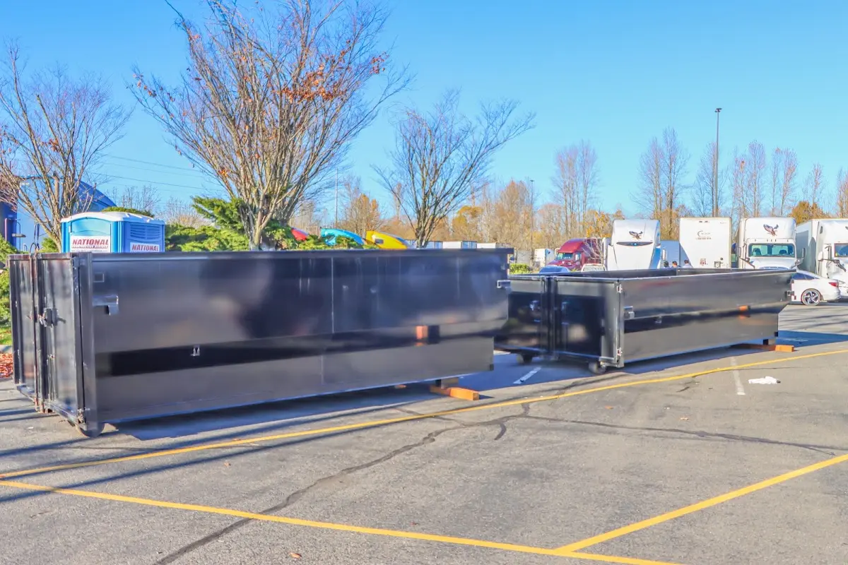 Professional dumpster rental service with roll-off container on residential driveway in East Whittier